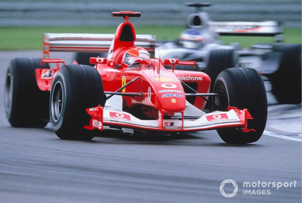 Michael Schumacher, Ferrari F2003 GA, leads Kimi Raikkonen, McLaren