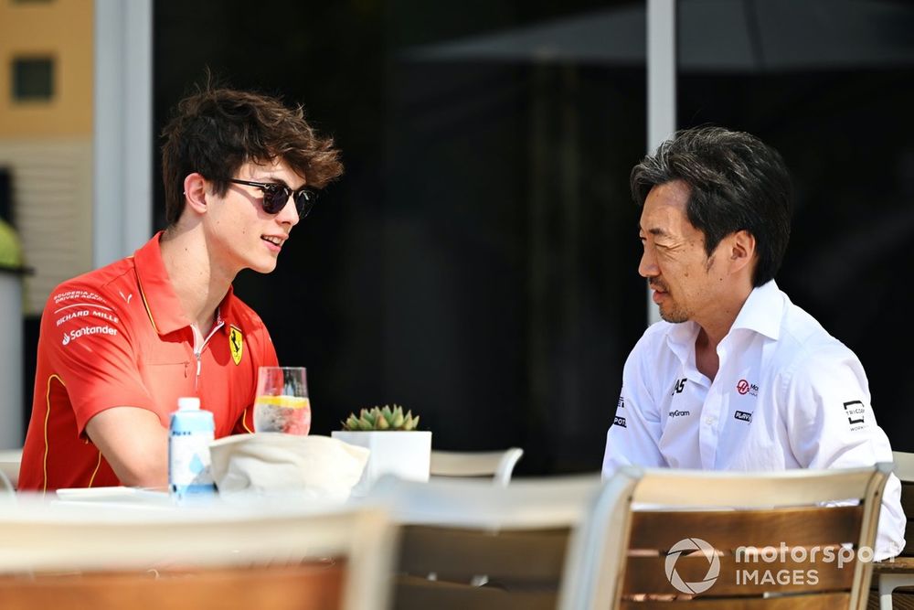 Oliver Bearman, Reserve Driver, Ferrari and Haas F1 Team, chats with Ayao Komatsu, Team Principal, Haas F1 Team 